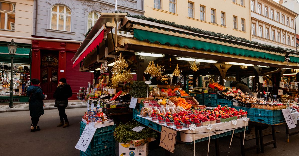 Explore a lively outdoor market stall with assorted fruits and vegetables, perfect for a local shopping experience.